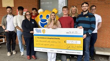 Members of the GRAND committee hold a giant cheque for the Children's Hospital