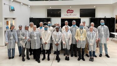 A group of students pose at Nestle 