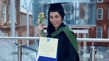 Dana Arabiyat on her graduation day stood with her graduation certificate.