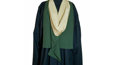 Back of a person wearing formal graduation robes for a masters