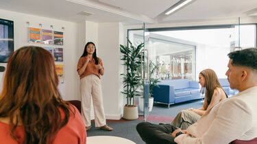 A students deliver a presentation in a seminar setting
