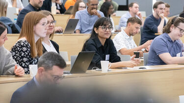 People sat in rows in a lecture theatre.