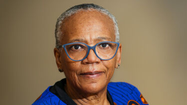 Headshot of a person wearing bold rimmed glasses