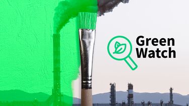a paint brush painting green over a photo of a polluting factory 