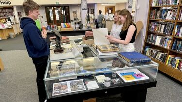 Holly Satterly browsing through materials related to the twinning partnership in Sheffield's Central Library.