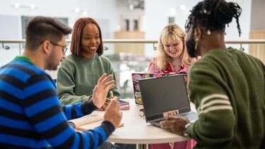 Four students meet in a cafe for a discussion