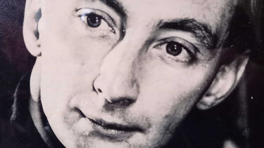 A close-up of Eric Pattison's face in black and white. 
