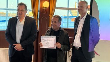 A researcher being presented with a certificate 