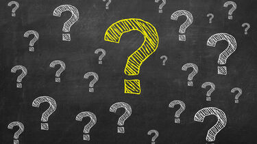 question marks drawn on a chalk board