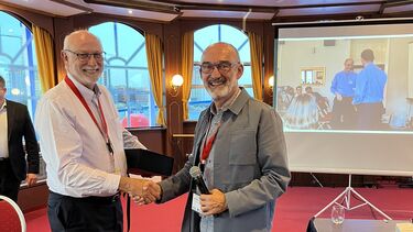 A researcher being presented with an award