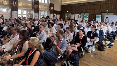 Conference attendees listen to a presentation 