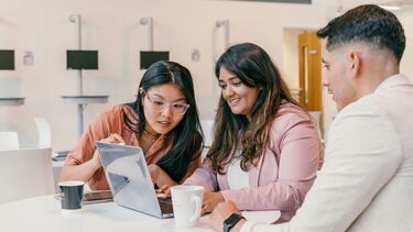 Students looking at laptop