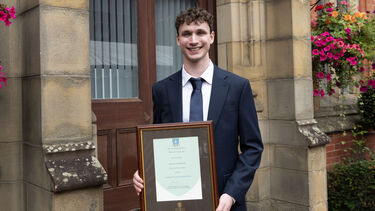 Sam Kerslake posing with certificate 