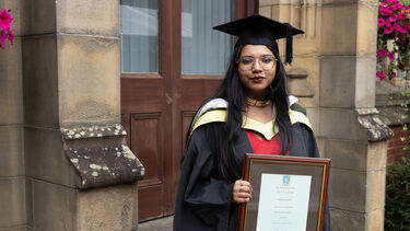 Upasana Mondal in graduation gown with certificate 