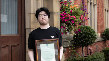 Wenhan Dai posing with certificate 