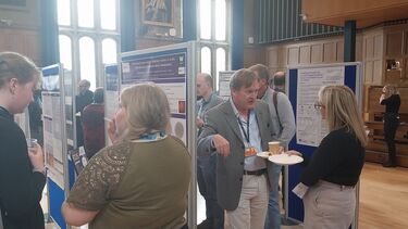 Attendees networking and poster viewing