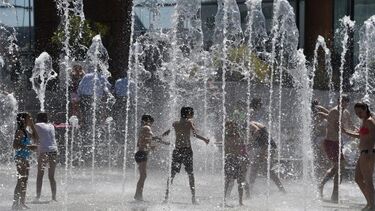 Children playing in an outdoor water fountain