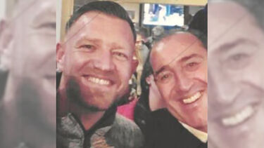 David and his son Wayne in the pub, smiling broadly for a selfie