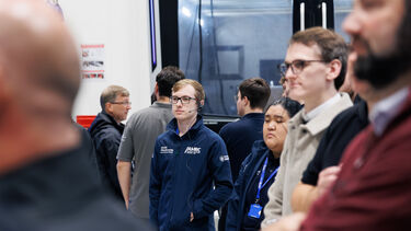 People wearing headsets looking at machines