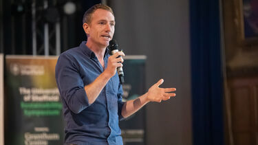 Jon Alexander talking onstage at the Sustainability Symposium 2025
