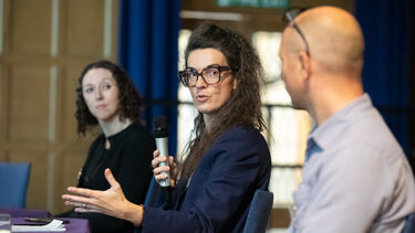  Professor Isabelle Doucet, Dr Dan Olner and Jeanine Griffin sitting on a panel at the Sustainability Symposium 2025