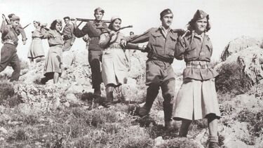 Communist fighters walking through Greek hills in the late 1940s