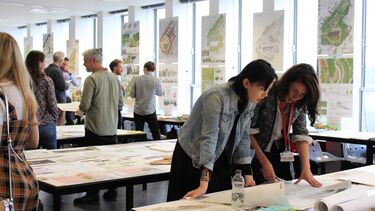 Staff and students looking at Landscape Architecture work in studios 