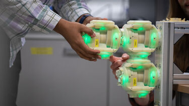 Image of a hand adjusting a robotics device