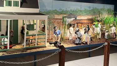 diorama, a scene with puppets that concentrates on plantation images including the cruelty of the punishments and the hard labour in the fields