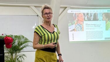 Louwerse presenting at the conference. Screen with presentation in the background