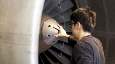 A student looking at an engine