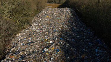 An 150 metre-long mountain of rubbish illegally dumped beside the A34 in Kidlington, Oxfordshire