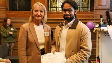 Anish is receiving the placement year award from a lady