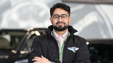 Anish is standing in from of a Bentley car