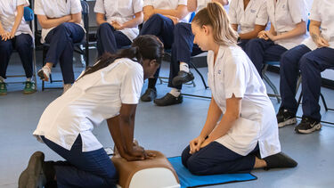 Two nursing students practicing basic life support.