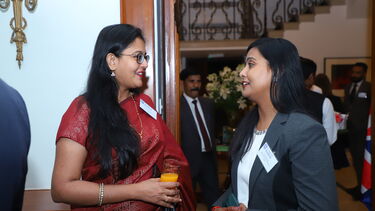 Two alumni chatting at the Alumni Reception in India