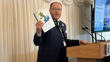  George Freeman MP speaks in parliament holding a physical copy of the white paper 