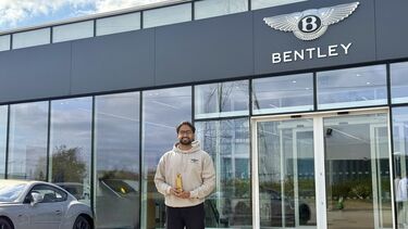 Anish is standing in front of Bentley office