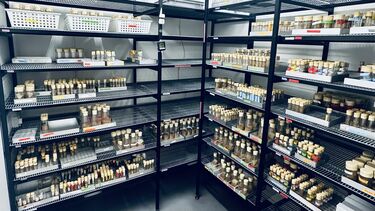 Inside the 25C culture room with metal shelving holding bottles of Drosophila.
