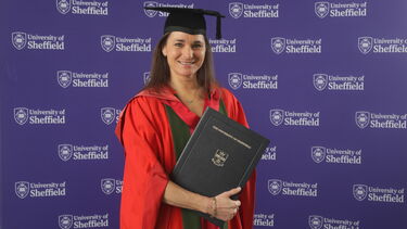 Dame Sarah Storey receiving an honorary degree wearing red and green robes