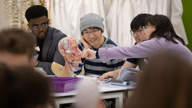 Image of students gathered around a Von Hagen sculpture