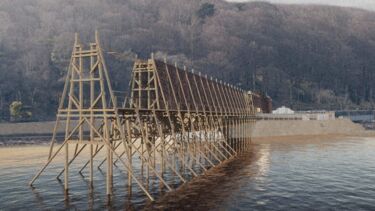A wooden bridge under construction over a body of water