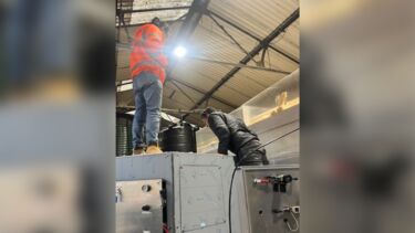 Professor Pandhal peering into the reactor during construction. 