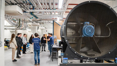 Applicants on a tour of the engineering facilities looking at the wind tunnel in the Mappin Building