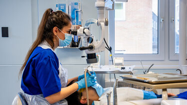 A DClinDent student working on a patient