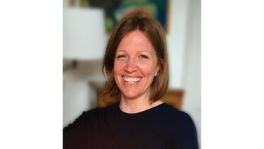 Kate, white woman with short hair, smiling to the camera.