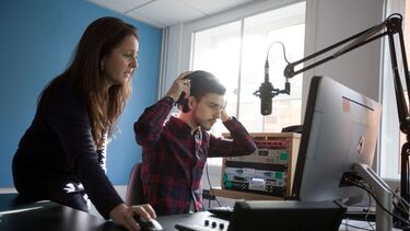 Student in headphones with lecturer