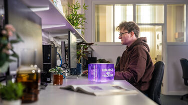 Image shows a student studying in a lab
