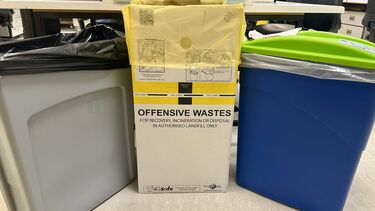 Three different coloured waste bins for the different waste streams in the lab.