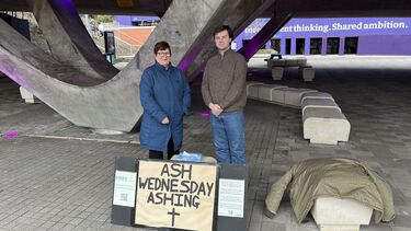 Team member Sue and student Brett offer ashing outside the Students' Union